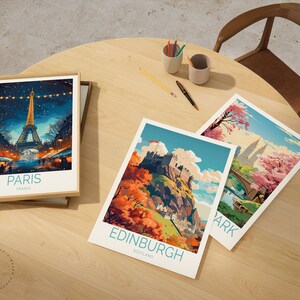May include: Three framed travel posters with illustrations of famous landmarks. The top poster features the Eiffel Tower in Paris, France. The middle poster features Edinburgh Castle in Edinburgh, Scotland. The bottom poster features Central Park in New York City, New York.