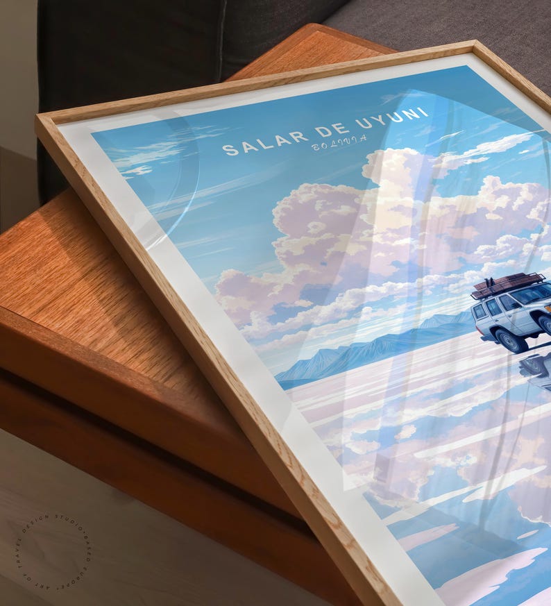 May include: A framed poster with a white car driving on a salt flat with a blue sky and white clouds. The poster says "Salar de Uyuni, Bolivia" in the top left corner.