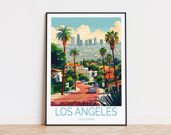 May include: A framed art print featuring a stylized illustration of Los Angeles, California. The artwork depicts a road winding through a residential area with palm trees, leading to a cityscape in the background. The text "LOS ANGELES CALIFORNIA" is at the bottom.