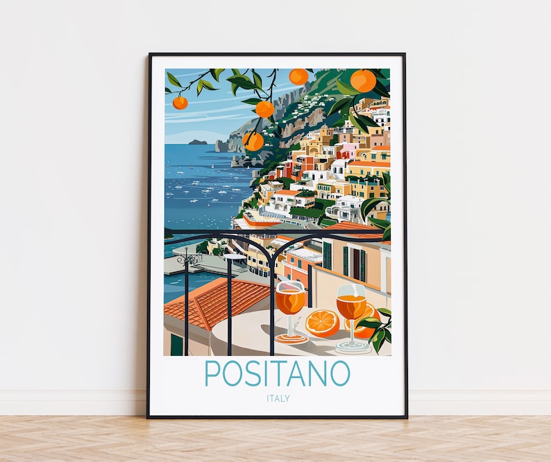 May include: A colorful illustration of Positano, Italy, with a view of the town from a balcony overlooking the Mediterranean Sea. The illustration features a glass of orange juice and a slice of orange on a table, with a lush orange tree in the foreground.