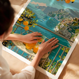 May include: A colorful illustration of a coastal town with a balcony overlooking the ocean. The balcony has a table with a glass of orange juice and oranges on it. The ocean is blue and the town is a mix of yellow, orange, and red buildings.