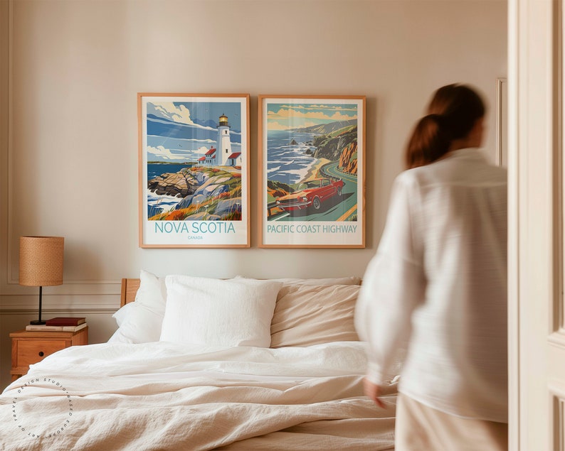 May include: Two framed travel posters hanging on a wall above a bed. The poster on the left shows a lighthouse on a rocky coast with the text "NOVA SCOTIA, Canada". The poster on the right shows a red car driving along a winding road with the text "PACIFIC COAST HIGHWAY".