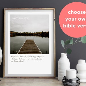 May include: A framed print with a photograph of a wooden dock extending into a lake. The sky is overcast and the water is calm. The print includes the text "Romans 15:13" and a bible verse: "May the God of hope fill you with all joy and peace in believing, so that by the power of the Holy Spirit you may abound in hope."