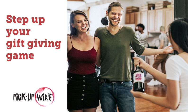 May include: Three people are smiling and laughing while holding a bottle of wine. The bottle has a pink and white label with the words "Pick-Up Wine" on it. The text "Step up your gift giving game" is in red letters on a white background.