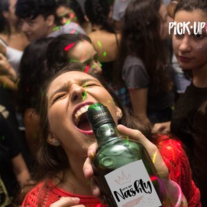 May include: A group of people at a party, one person is holding a bottle of wine with a label that says "Let's Get Nasty".