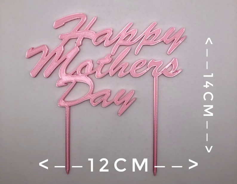 May include: Pink acrylic cake topper with the words "Happy Mothers Day" in a cursive font. The topper is 14 cm tall and 12 cm wide.