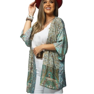 May include: A light blue and green patterned kimono with a brown belt. The kimono has a floral design and is made of a lightweight fabric.