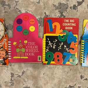 May include: A set of vintage children's educational books. Titles include "Round the Clock Book", "The Color Wheel Book", "The Big Counting Book", and "The Big ABC Book". Each book features colourful illustrations and educational content.