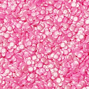 May include: Pink sugar sprinkles in the shape of small, irregular circles. The sprinkles have a pearlescent finish.