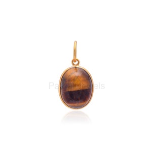 May include: Gold pendant featuring a brown and gold oval tiger's eye gemstone.