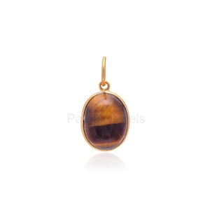 May include: Gold pendant featuring a brown and gold oval tiger's eye gemstone.