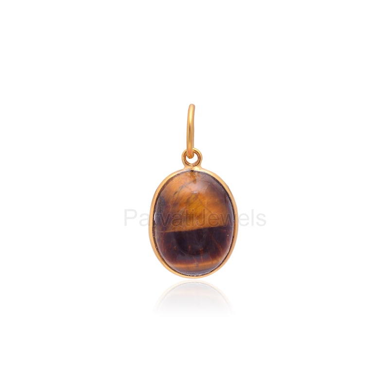 May include: Gold pendant featuring a brown and gold oval tiger's eye gemstone.