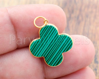 May include: Gold-tone pendant featuring a green malachite clover design. The pendant has a loop at the top for attaching to a chain.