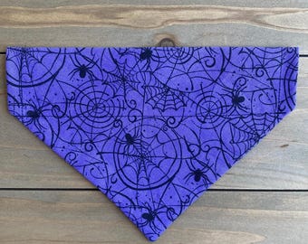May include: Purple bandana with a black spiderweb and spider pattern.