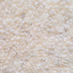 May include: Close-up of a white, fluffy, textured fabric. The fabric has a soft, fuzzy appearance.