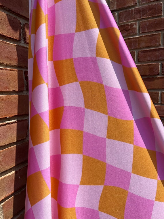 STRETCH PRINT FABRIC - Pink and Orange wavy checkerboard print fabric on 4 way Stretch print poly spandex fabric