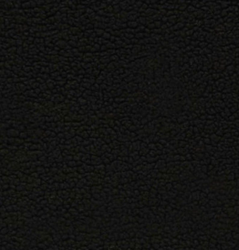 May include: Black fuzzy fabric with a textured surface.