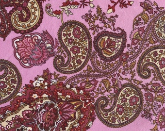 May include: Pink fabric with a paisley pattern in shades of brown, red, and cream.