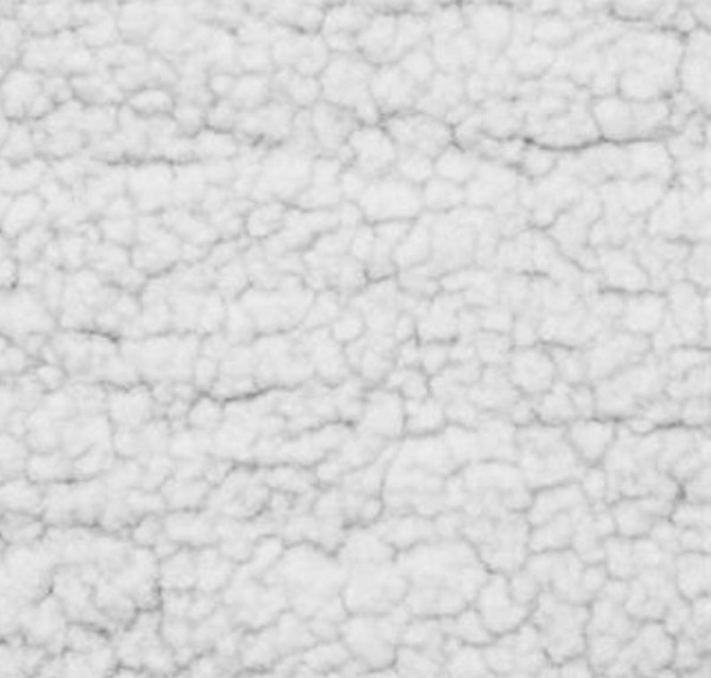May include: White faux fur fabric with a soft, fluffy texture. The fabric has a slightly textured surface with a subtle pattern.