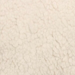 May include: Close-up of a soft, white, fluffy fabric with a textured surface.
