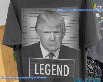 DONALD TRUMP "LEGEND" Mugshot Shirt | Unisex high res cotton trump mugshot shirt.