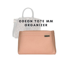 May include: A light pink felt bag organiser with the text "GREEN BAG" on a small label. The organiser is designed to fit inside a Louis Vuitton Odeon Tote MM handbag.