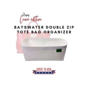 May include: White tote bag organizer with a double zipper closure. The organizer is made of 2mm thick felt and has a label that says "Made in USA".