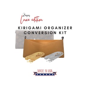 May include: A Kirigami organizer conversion kit with a brown felt insert, a patterned envelope, and two chain straps, one gold and one silver. The text reads "2mm Luxe edition" and "KIRIGAMI ORGANIZER CONVERSION KIT". Made in the USA.