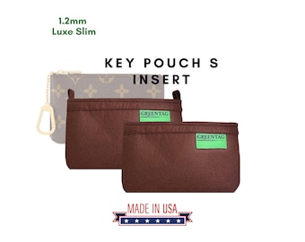 May include: A brown felt key pouch insert with a green "GREENTAG" label. The insert is designed to fit inside a luxury key pouch. The text "KEY POUCH INSERT" and "MADE IN USA" are also visible in the image.