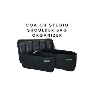 May include: Black quilted shoulder bag with a gold buckle and two black felt bag organizers with green "Greentags" labels.  COA.CH STUDIO SHOULDER BAG ORGANIZER.
