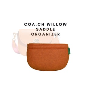 May include: A brown felt bag organiser for a Coach Willow Saddle bag. The organiser has a green label that says "GreenTote".