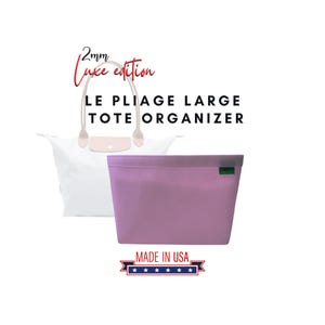 May include: A light purple tote bag organizer with a green zipper pull. The organizer is made in the USA and is designed to fit inside a large tote bag. The text "2mm Luxe edition" and "LE PLIAGE LARGE TOTE ORGANIZER" is visible in the image.