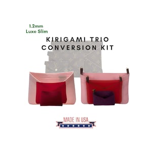 May include: A Kirigami Trio Conversion Kit with the text "1.2mm Luxe Slim" and "Kirigami Trio Conversion Kit". The kit includes two pink and red fabric inserts with smaller red and purple inserts. The words "Made in USA" are also visible.