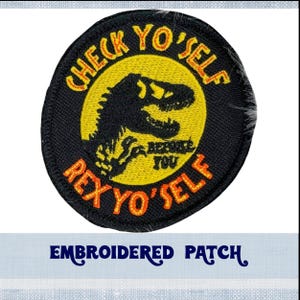 May include: Embroidered patch with a black background and a yellow circle in the centre. The circle has the text "Check Yo'Self Rex Yo'Self" in orange and black lettering. A black silhouette of a dinosaur is in the centre of the circle.