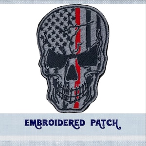 May include: Embroidered patch of a gray skull with a red and white American flag design. The text "EMBROIDERED PATCH" is below the skull.