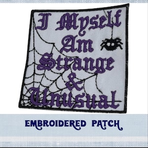 May include: Embroidered patch with a white background and black spider web design. The text "I Myself Am Strange & Unusual" is embroidered in purple.