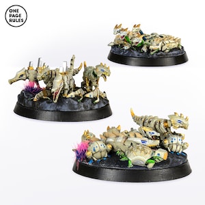 May include: Three white and gold painted miniature plastic figures of a creature with a long tail and a head with a mouth full of teeth. The figures are posed in a fighting stance on a black base with a gray and brown textured surface. The figures are painted with details of blue, green, and gold.