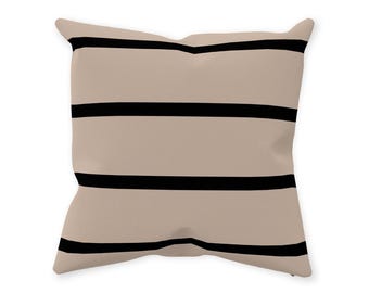 May include: A beige throw pillow with black horizontal stripes.