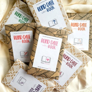 May include: A collection of books wrapped in brown paper with leaf patterns, each featuring a white label that reads Blind Date with a Book. The labels include various genre icons and text in blue, green, orange, red, pink, purple, and brown ink.