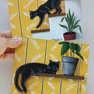 Décoration murale chat noir – Lot de 2 tableaux de chat noir – Décoration de chat fantaisiste – Œuvre d'art moderne pour les amoureux des chats – Chat mignon dans une pièce avec des plantes