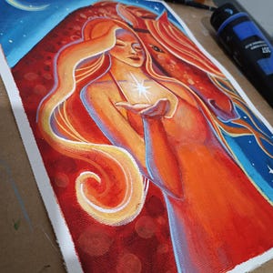 May include: An acrylic painting on canvas depicts a woman with long orange hair and a horse. The woman holds a glowing star. The background features a blue sky with a crescent moon and stars. The artwork uses warm colors like red, orange, and yellow.