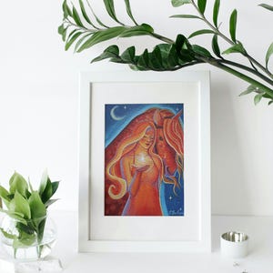 May include: A framed art print featuring a woman with long, flowing red hair holding a glowing star, alongside a red horse. The background shows a starry night sky with a crescent moon. The artwork is in a white frame.