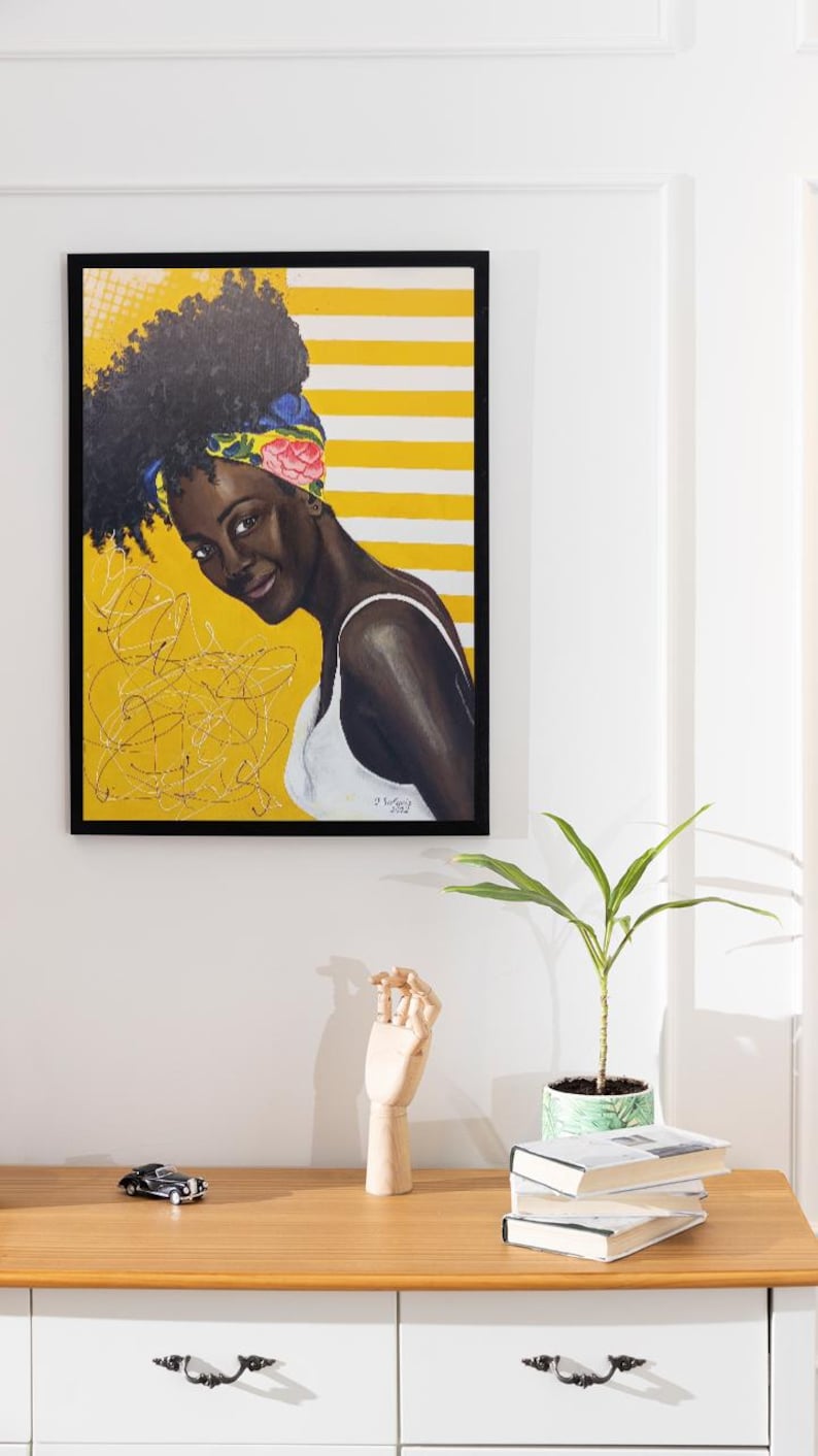 Modern dining room featuring the original Black woman portrait displayed on a neutral wall above a white sideboard
