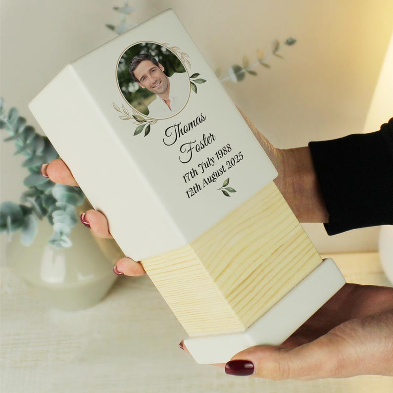 May include: White wooden box with a photo of a man and the text "Thomas Foster 17th July 1988 12th August 2025".