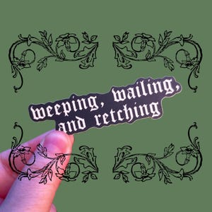 May include: Black and white sticker with the text "weeping, wailing, and retching" in a gothic font.