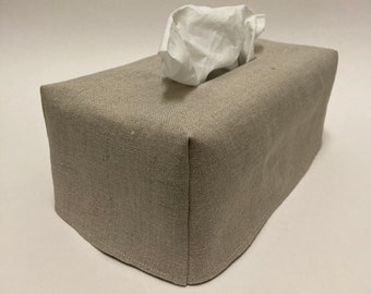 May include: A beige linen tissue box cover with a white tissue box inside.
