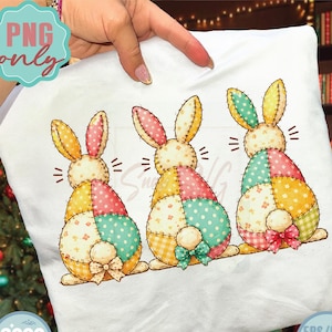 May include: A white pillowcase featuring three cartoon Easter bunnies with patchwork-style bodies in pastel colors. Each bunny has a bow and is facing away. The image includes the text "Digital Download" and SVG/PNG icons.