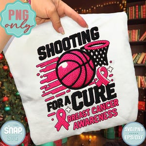 May include: White t-shirt featuring a basketball design with the text "SHOOTING FOR A CURE BREAST CANCER AWARENESS". The design includes a pink basketball, a net, and a pink ribbon, all in a bold, eye-catching style.