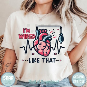 May include: A white t-shirt with a graphic of a heart with an EKG line and the text "I'm Wired Like That".