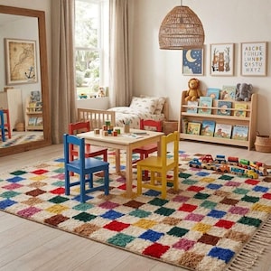 May include: A children's playroom featuring a multi-coloured rug with a checkered design. A small wooden table and chairs are set up for play. A bookshelf displays books and toys. The room is decorated with framed pictures and a woven pendant light.